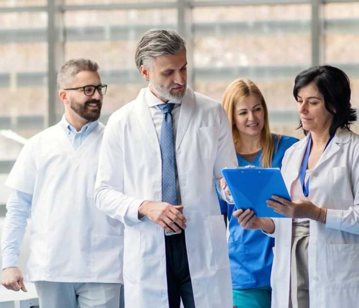 group-of-doctors-walking-in-corridor-on-medical-co-WHEP3XW-b.jpg